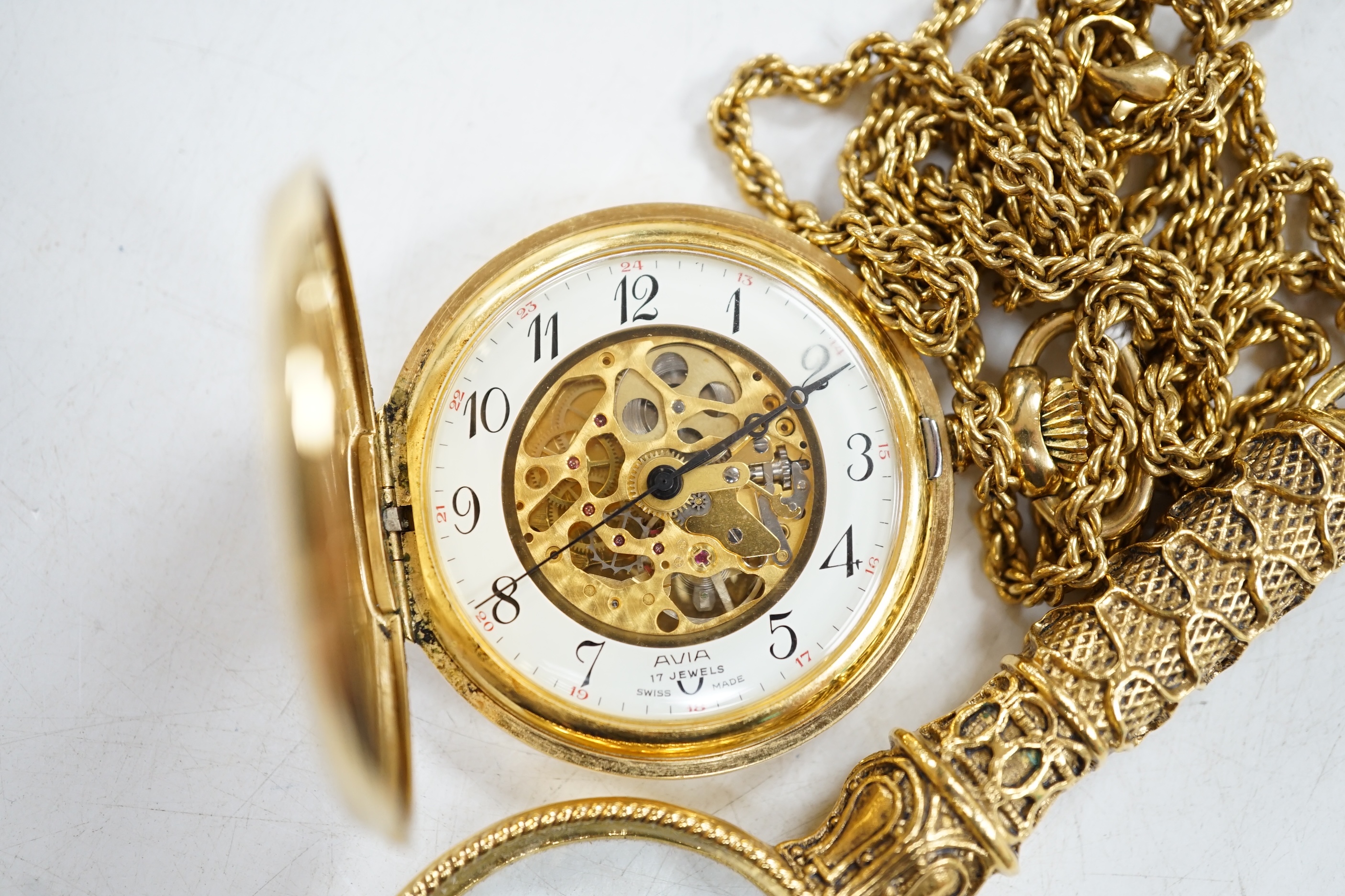 A gold plated Avia keyless pocket watch, on gilt chain with magnifying glass. Condition - fair